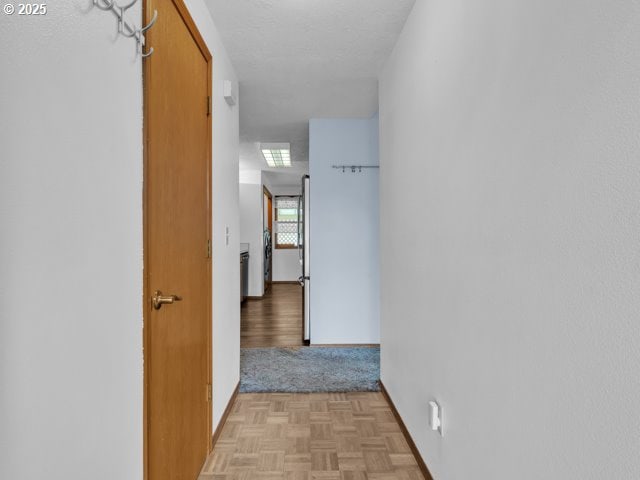hall featuring baseboards