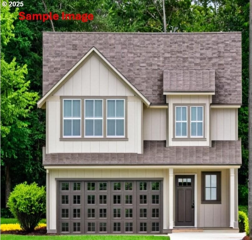 view of front of property with an attached garage, board and batten siding, and a shingled roof