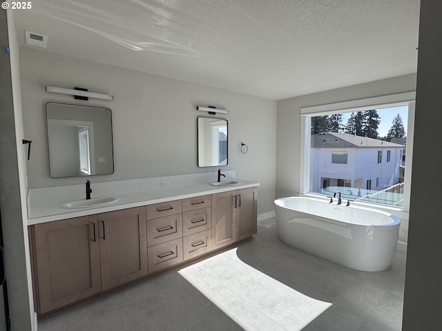 844 NE 17th Ave, Canby, OR 97013 - full bath with a textured ceiling, double vanity, and a freestanding bath
