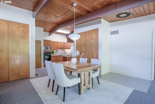 1439 Barton St, Eugene, OR 97404 - dining space with wooden ceiling with exposed beams and light colored carpet