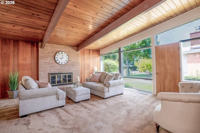 1439 Barton St, Eugene, OR 97404 - carpeted living area with wood walls, wood ceiling with exposed beams, and a glass covered fireplace