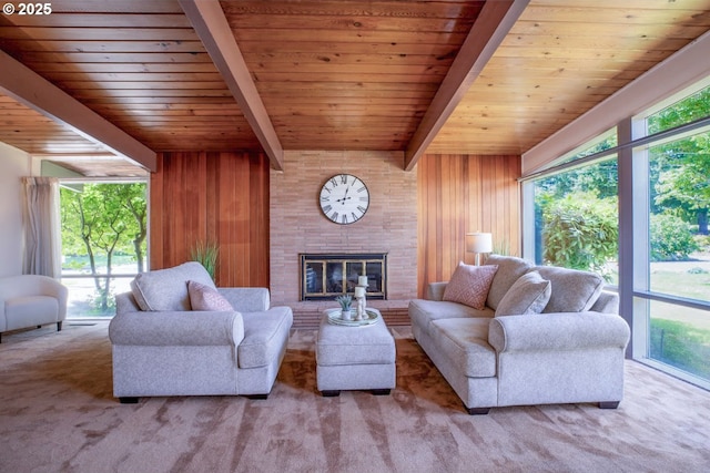 1439 Barton St, Eugene, OR 97404 - living area featuring wood walls, wood ceiling with exposed beams, a glass covered fireplace, and carpet