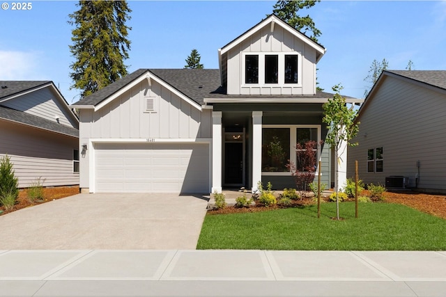 16401 SW Cambridge Ln, Durham, OR 97224 - view of front facade with board and batten siding, an attached garage, driveway, a front yard, and roof with shingles