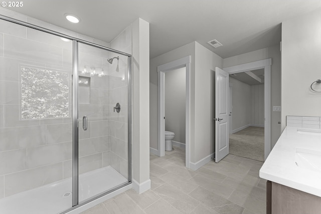 16401 SW Cambridge Ln, Durham, OR 97224 - bathroom featuring a stall shower, double vanity, toilet, and baseboards