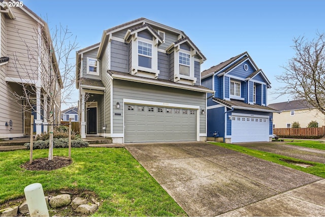 traditional home with a front yard, driveway, an attached garage, and fence