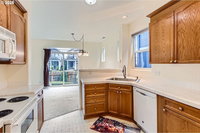 20372 SW Verona Ct, Beaverton, OR 97003 - kitchen with white appliances, brown cabinets, tile countertops, light colored carpet, and a peninsula