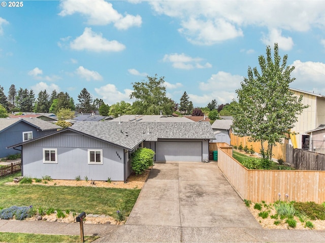 view of front of house featuring concrete driveway, a garage, and roof with shingles