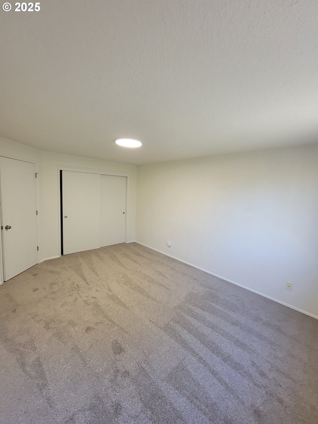 unfurnished bedroom with carpet flooring and a textured ceiling