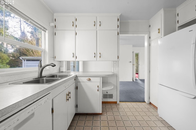 kitchen featuring white appliances, crown molding, white cabinetry, and a sink