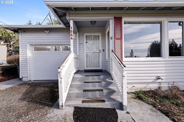 view of exterior entry with a garage