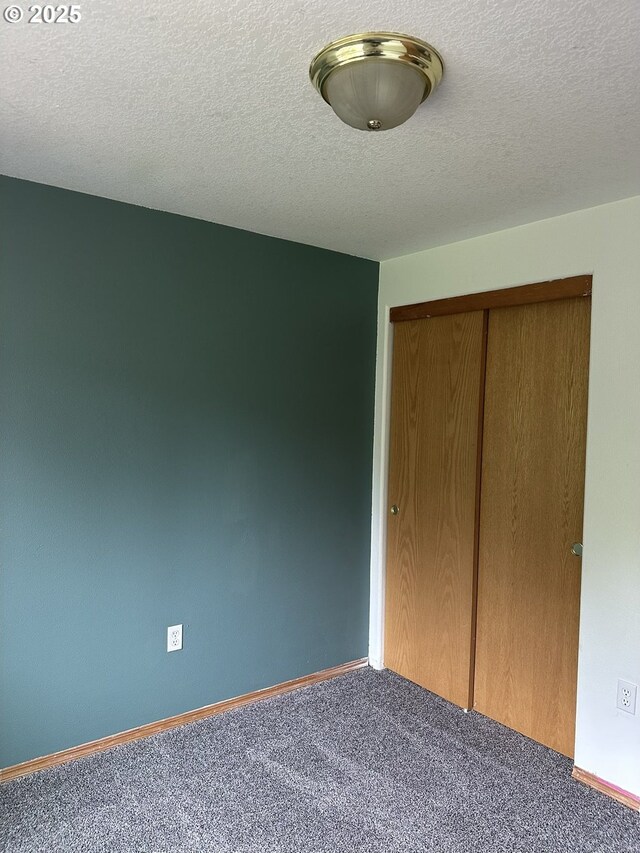 14237 SE Lee Ave, Milwaukie, OR 97267 - unfurnished bedroom featuring carpet flooring, a closet, a textured ceiling, and baseboards