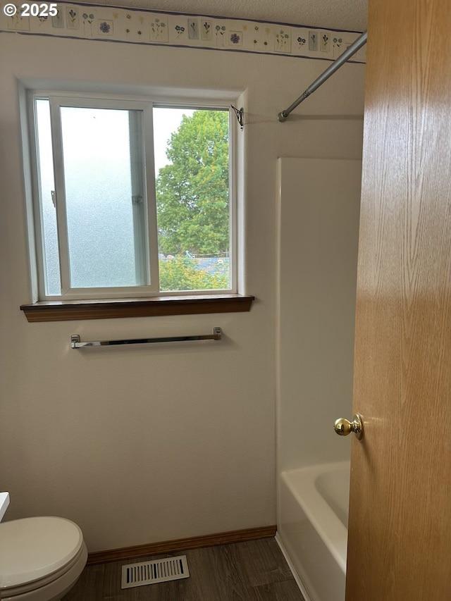 14237 SE Lee Ave, Milwaukie, OR 97267 - bathroom featuring baseboards, healthy amount of natural light, toilet, and shower / washtub combination