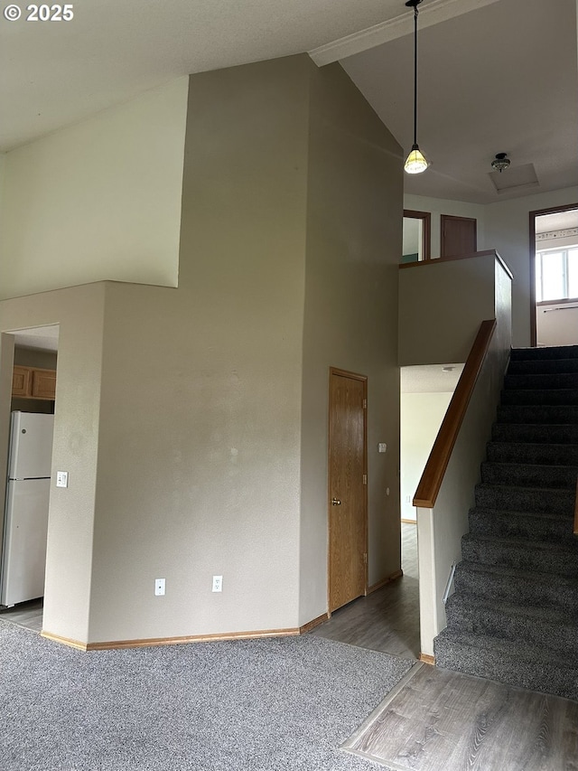 14237 SE Lee Ave, Milwaukie, OR 97267 - stairs with baseboards, wood finished floors, high vaulted ceiling, and carpet flooring
