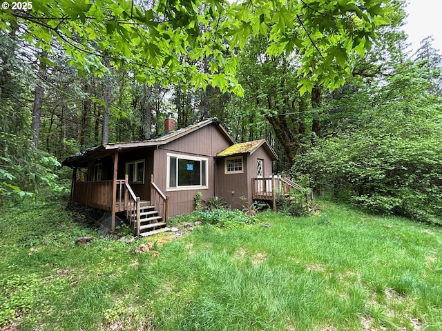 56294 Hall Dr, Mckenzie Bridge, OR 97413 - view of home's exterior featuring a chimney, a deck, and a forest view