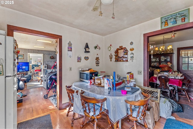 dining room featuring an inviting chandelier and wood-type flooring