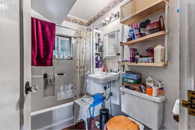 full bathroom with sink, shower / tub combo with curtain, and toilet