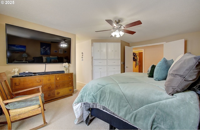 carpeted bedroom featuring ceiling fan and a closet