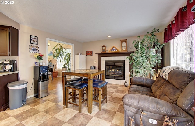 dining room featuring a tile fireplace