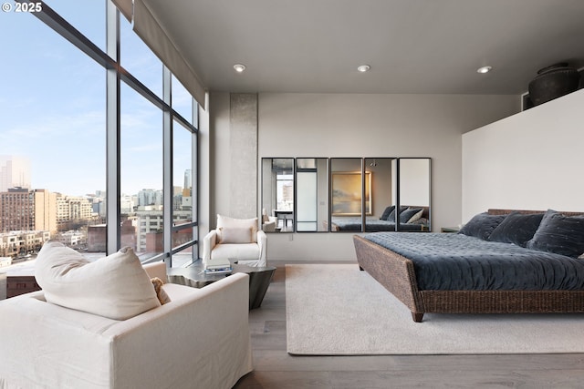 bedroom featuring floor to ceiling windows and wood-type flooring