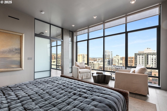 bedroom featuring hardwood / wood-style flooring and floor to ceiling windows