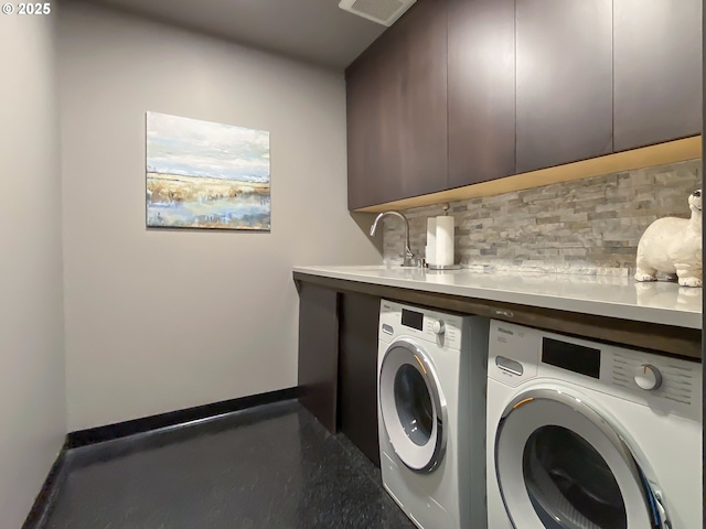 laundry room with cabinets, sink, and independent washer and dryer