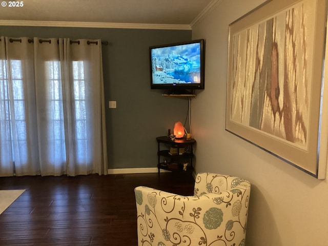 sitting room featuring dark wood-type flooring and ornamental molding