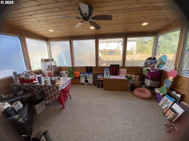 sunroom featuring ceiling fan and wood ceiling