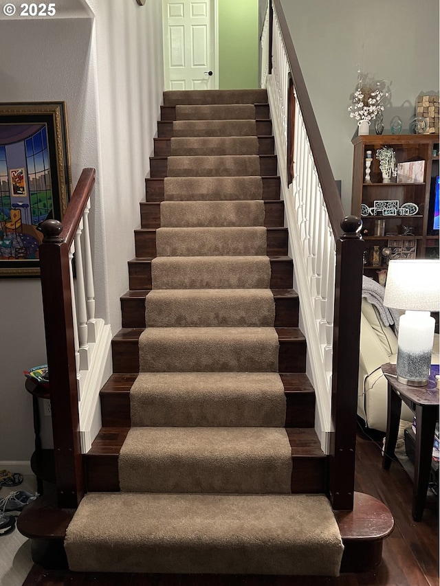 staircase featuring hardwood / wood-style flooring