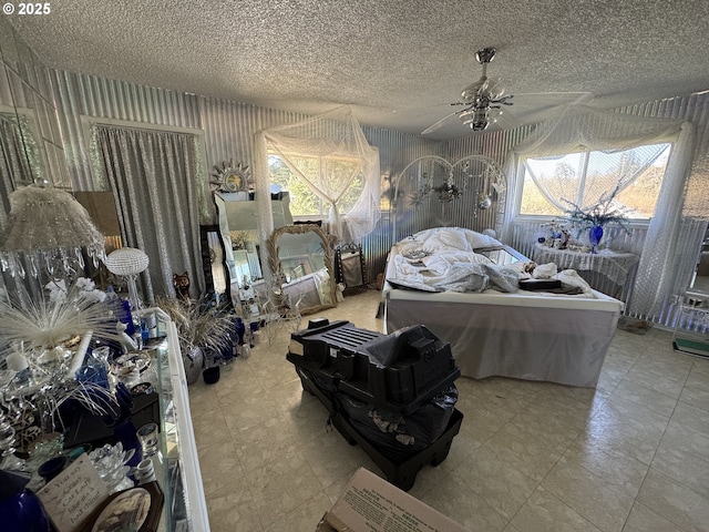 bedroom with wallpapered walls, multiple windows, and a textured ceiling