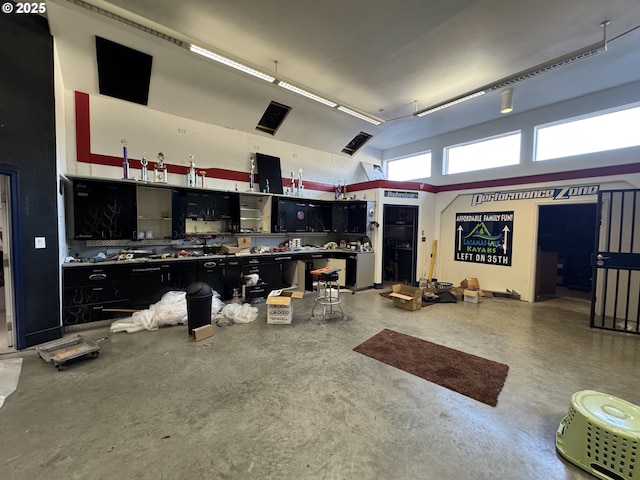 interior space featuring concrete floors and a high ceiling