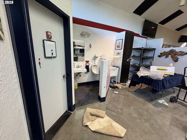 interior space with a sink and baseboards