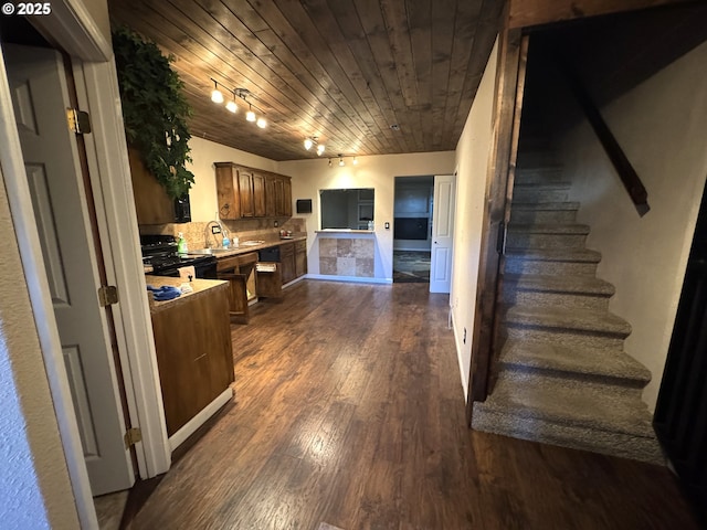 kitchen featuring tasteful backsplash, wood ceiling, dark wood-style flooring, black electric range oven, and light countertops