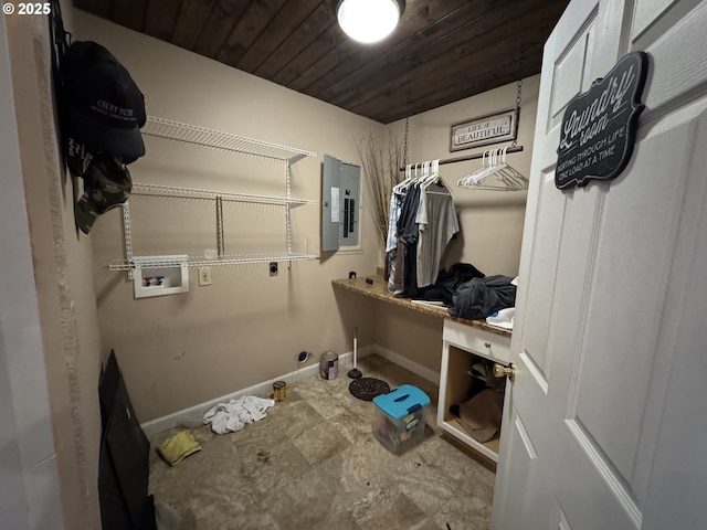 mudroom featuring wood ceiling, electric panel, and baseboards