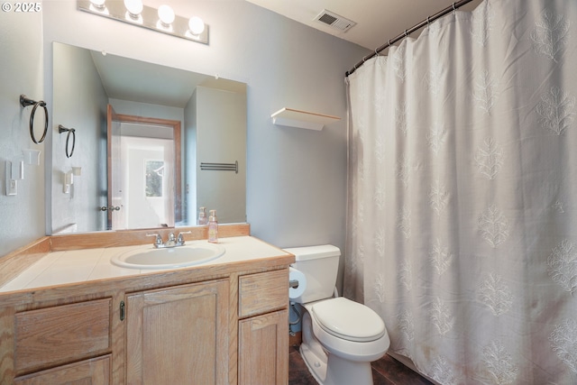 full bathroom featuring visible vents, toilet, and vanity