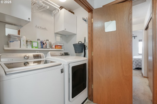 laundry area with light colored carpet, cabinet space, and washer and clothes dryer