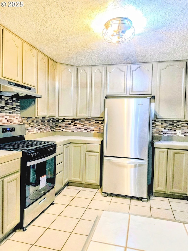 123 1st St, Dillard, OR 97432 - kitchen with stainless steel appliances, under cabinet range hood, light countertops, backsplash, and a textured ceiling