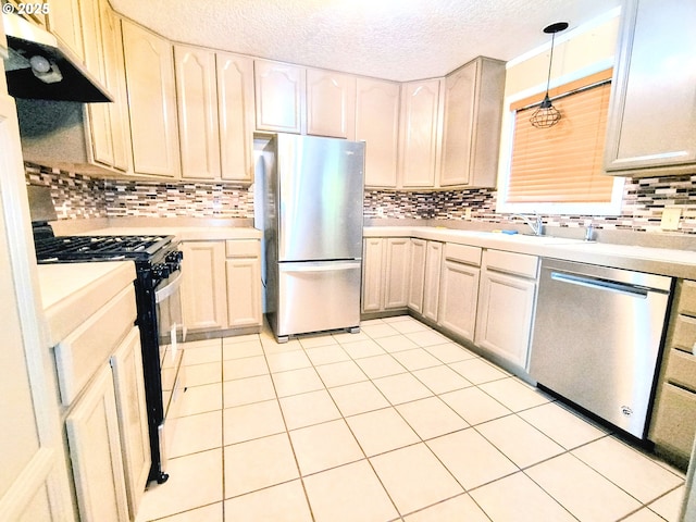 123 1st St, Dillard, OR 97432 - kitchen with stainless steel appliances, under cabinet range hood, light countertops, and a textured ceiling