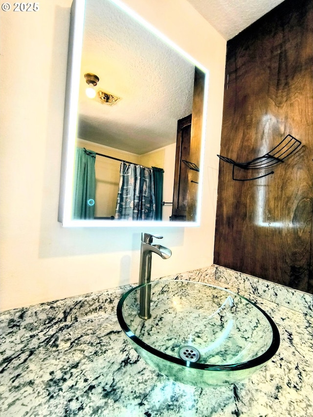 123 1st St, Dillard, OR 97432 - bathroom view of a sink and a textured ceiling