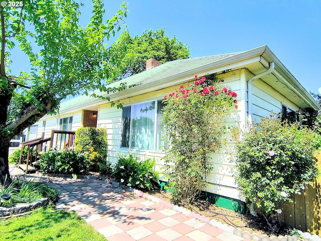 123 1st St, Dillard, OR 97432 - view of front facade with a patio, a chimney, and fence