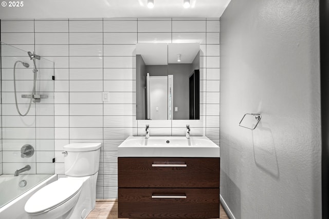 4360 SW Dickinson St Unit 35, Portland, OR 97219 - full bathroom featuring vanity, toilet, tile walls, shower / washtub combination, and decorative backsplash