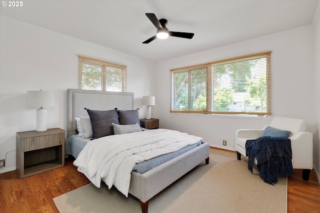 4429 SE Raymond St, Portland, OR 97206 - bedroom featuring multiple windows, wood finished floors, and ceiling fan