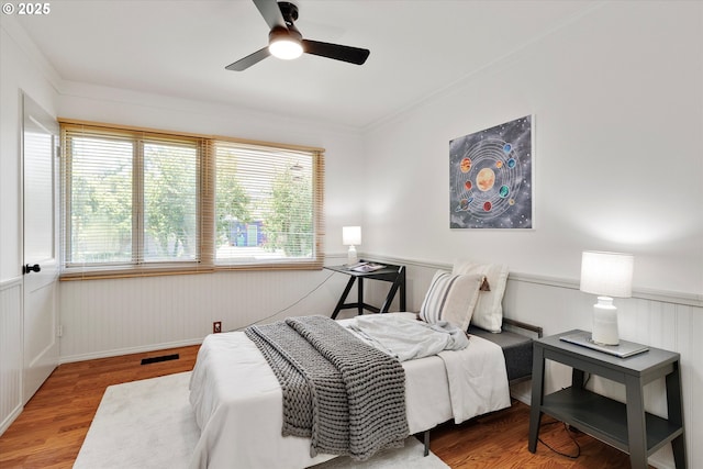 4429 SE Raymond St, Portland, OR 97206 - bedroom featuring wainscoting, wood finished floors, ornamental molding, and ceiling fan