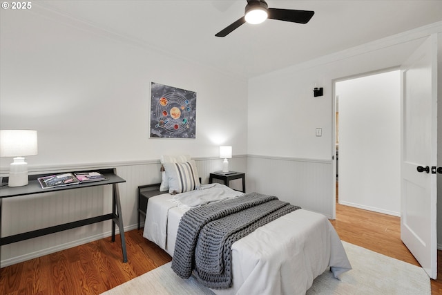 4429 SE Raymond St, Portland, OR 97206 - bedroom with wood finished floors, wainscoting, ornamental molding, and ceiling fan