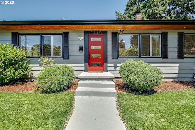 4429 SE Raymond St, Portland, OR 97206 - view of front of home featuring a front yard and a chimney