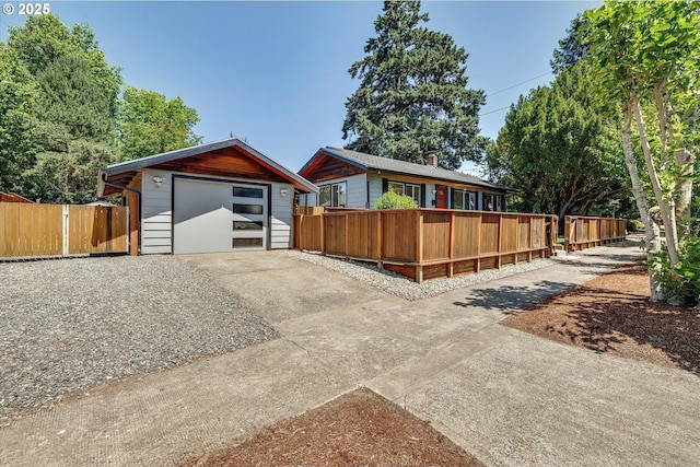 4429 SE Raymond St, Portland, OR 97206 - view of front of home with concrete driveway, an outbuilding, and a detached garage