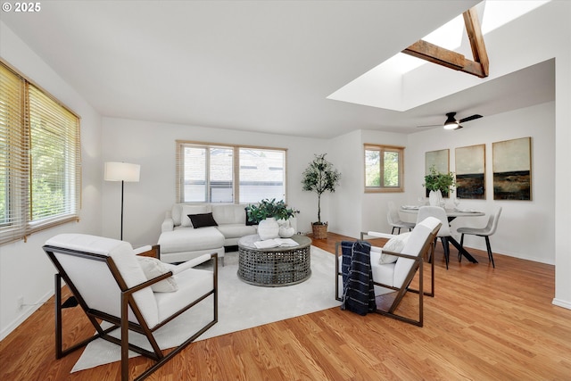 4429 SE Raymond St, Portland, OR 97206 - living area featuring a skylight, light wood finished floors, and ceiling fan