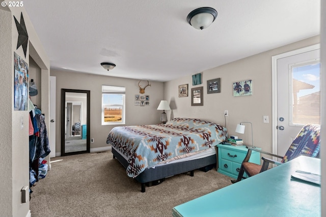 carpeted bedroom featuring baseboards