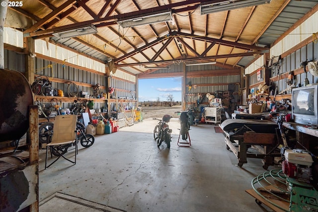 garage with a workshop area and metal wall