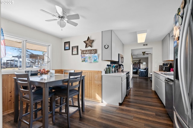 kitchen with dark wood-style flooring, light countertops, visible vents, appliances with stainless steel finishes, and ceiling fan