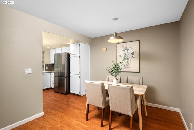 1771 NW 143rd Ave Unit 38, Portland, OR 97229 - dining room with light wood-style flooring and baseboards